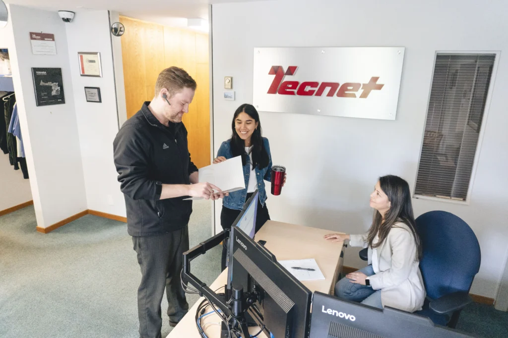 Tecnet IT support team collaborating in a modern office on IT solutions in Victoria, BC.
